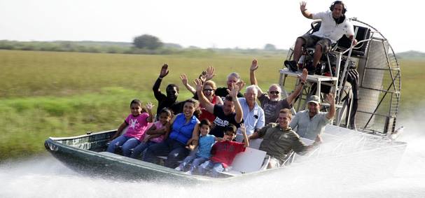 a group of kids and adults enjoying an airboat ride