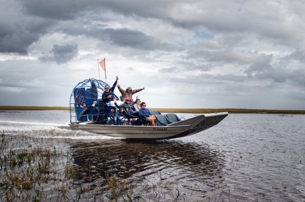 a group of tourists on an airboat tour