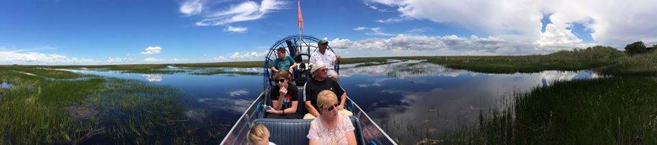 tourists exploring the Everglades through an airboat ride